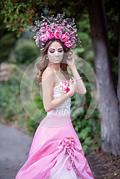 Closeup portrait of Calavera Catrina in pink dress. Sugar skull makeup. Dia de los muertos. Day of The Dead. Halloween