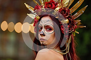 Closeup portrait of Calavera Catrina in red dress. Sugar skull makeup. Dia de los muertos. Day of The Dead. Halloween