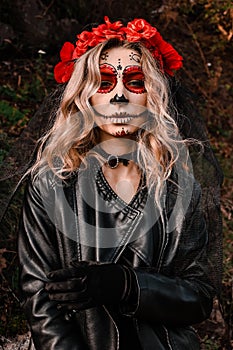 Closeup portrait of Calavera Catrina. Young woman with sugar skull makeup. Dia de los muertos. Day of The Dead