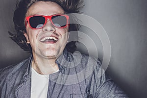 Closeup portrait of a casual young man with sunglasses