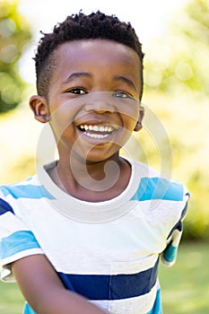 Closeup portrait of cheerful african american cute boy smiling and looking at camera