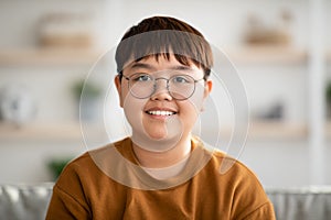 Closeup portrait of cheerful chubby asian kid smiling at camera