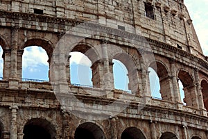 Closeup portrait of Coliseum building old wall with arch in Rome