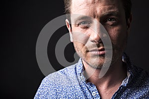 Closeup portrait of confident man on black background.