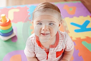 Closeup portrait of cute adorable blond Caucasian smiling child boy with blue eyes