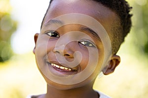 Closeup portrait of cute african american smiling boy looking at camera