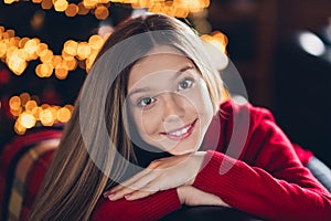 Closeup portrait of cute happy young girl teenage folded palms sitting on corner couch at home santa claus fan waiting