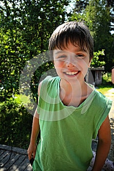 Closeup portrait cute little boy smiling in a park