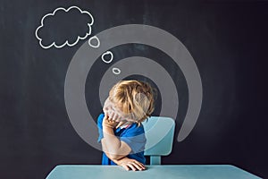 Closeup portrait of Cute little boy thinking deeply about someth