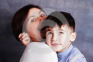 Closeup portrait of cute little boy and woman brunette. Mother and her son hugging
