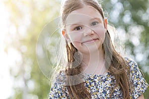 Closeup portrait of cute smiling girl with brown hair