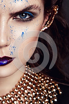 Closeup portrait with deep blue eye, creative makeup