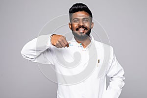 Closeup portrait of dentist holding up toothbrush and thumbs up sign, isolated on white background