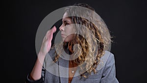 Closeup portrait of disturbed and nervous young caucasian female looking on the sides and straight at camera with the