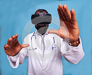Closeup portrait of doctor using virtual reality goggles and moving hands