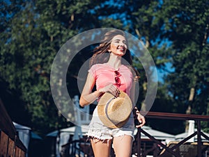 Closeup portrait of effective girl with long curly hair smiling to camera having fun on the beach, dancing and smiling, vacation m