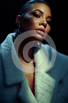 Closeup portrait of an elegant and beautiful african american young woman with perfect smooth glowing mulatto skin, full lips
