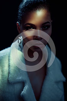 Closeup portrait of an elegant and beautiful african american young woman with perfect smooth glowing mulatto skin, full lips