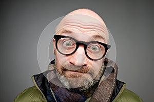 Closeup portrait of european funny mature man thinking trying hard to remember something looking confused