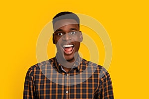 Closeup Portrait Of Excited African American Guy Looking At Camera With Amazement