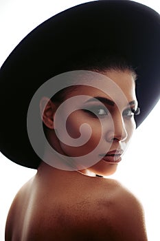 Closeup portrait of an extraordinary beautiful stylish metis young woman with perfect smooth glowing mulatto skin in a hat