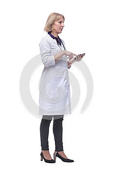 Closeup portrait of female doctor with stethoscope, healthcare professional texting on phone