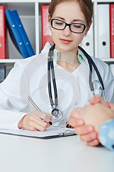 Closeup portrait of female doctor taking notes in medical history.