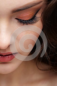 Closeup portrait of female face with red lips and smoky eyes beauty makeup