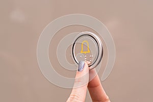 Closeup portrait of a female finger pushing elevator button