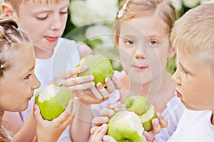 Closeup portrait of four children who eat green