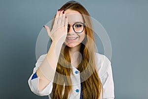 Closeup portrait of friendly, smiling confident female doctor, healthcare professional with labcoat and hand covering