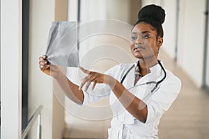 Closeup portrait of friendly, smiling confident female healthcare professional with lab coat, stethoscope, arms crossed. 