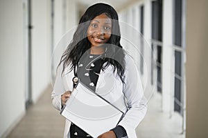 Closeup portrait of friendly, smiling confident female healthcare professional with lab coat, stethoscope.  hospital