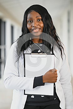Closeup portrait of friendly, smiling confident female healthcare professional with lab coat, stethoscope.  hospital