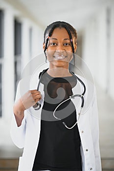 Closeup portrait of friendly, smiling confident female healthcare professional with lab coat, stethoscope. Isolated hospital