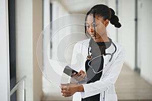 Closeup portrait of friendly, smiling confident female healthcare professional with lab coat, stethoscope. Isolated hospital