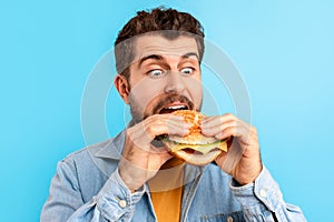 Closeup Portrait Of Funny Guy Eating Burger Enjoying Cheat Meal