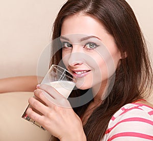 Closeup portrait of girl drinking milk from glass