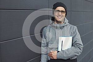 Closeup portrait of handsome 30-35 years old man outdoors standing near the wall