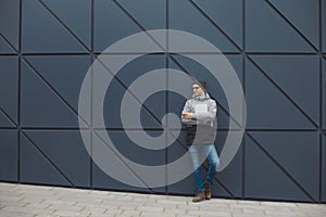 Closeup portrait of handsome 30-35 years old man outdoors standing near the wall