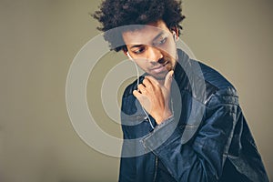 Closeup portrait of handsome African American man listening to music