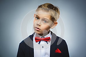 Closeup Portrait of handsome boy with astonished expression on grey background