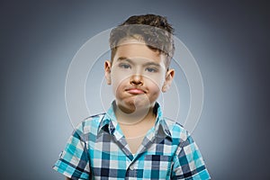 Closeup Portrait of handsome boy with astonished expression on grey background