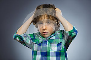 Closeup Portrait of handsome boy with astonished expression on grey background