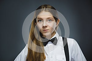 Closeup Portrait of handsome girl with astonished expression while standing against grey background