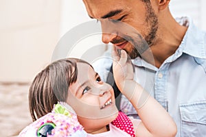 Closeup portrait of handsome happy young father embrace his daughter after preschool day. Cute little girl looking to his dad