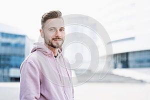 Closeup portrait of handsome smiling young man, Cheerful businessman in a city