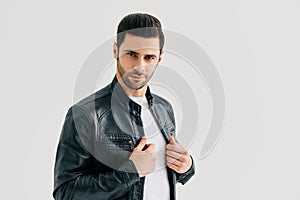 Closeup portrait of handsome trendy man posing on white studio background