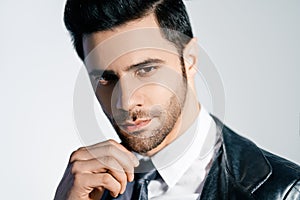 Closeup portrait of handsome trendy man posing on white studio background