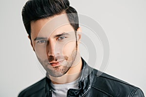 Closeup portrait of handsome trendy man posing on white studio background